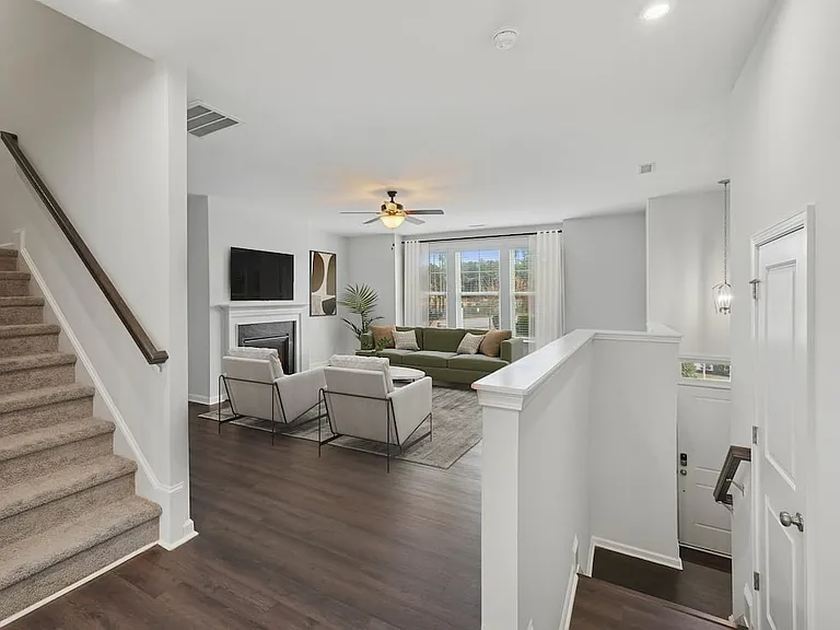 Upgrade Package Living room with hard-surface vinyl plank flooring throughout and fireplace
