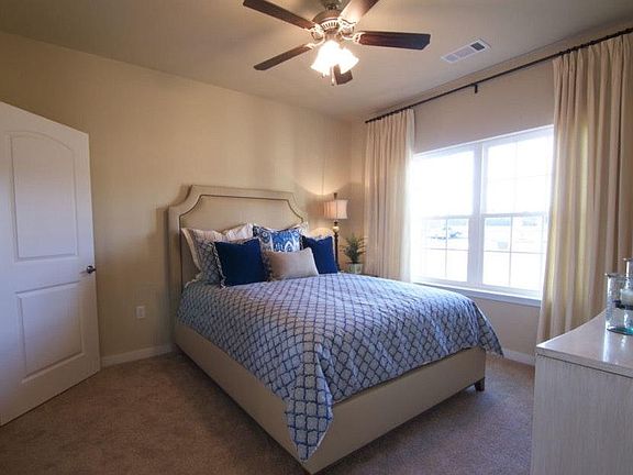 Master bedroom has carpet, ceiling fan, lots of natural ligh