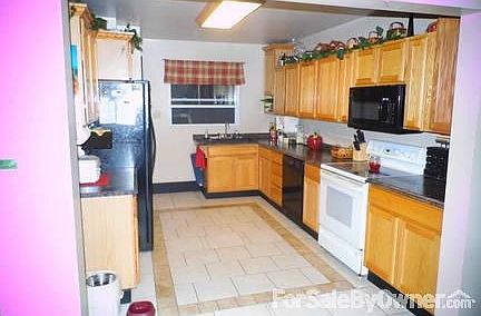 newly updated kitchen with light oak Merillat cabinets with slide out shelves