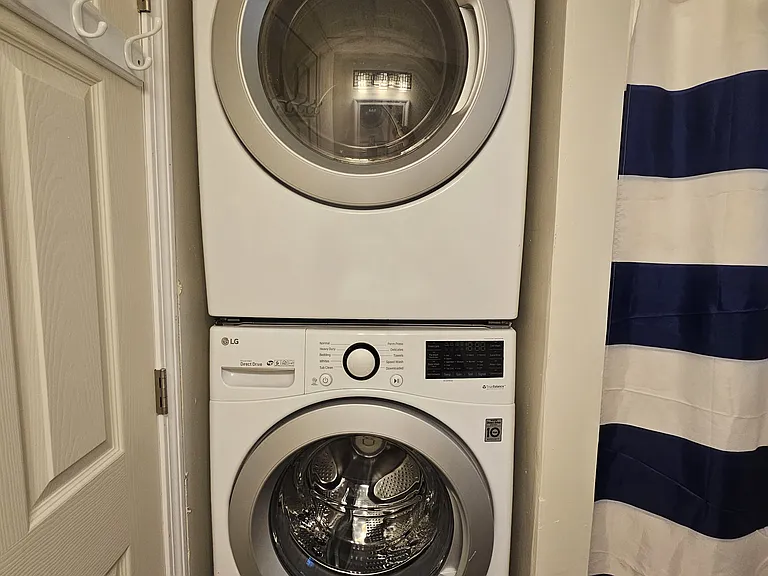 Stackable LG washer and dryer in bathroom.