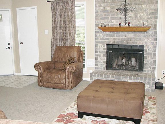 View from kitchen to cozy, brick fireplace.