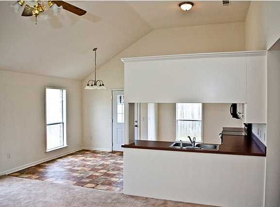 View from living towards dining and kitchen. This is a nice, large, open space accented by the tall, vaulted ceilings.