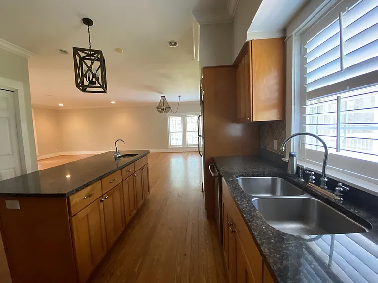 Kitchen, with seperate sink in the island. Dishwasher, stove, microwave and refrigerator.