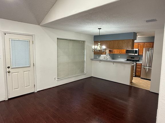 Dining room is directly off kitchen and adjacent to breakfast bar