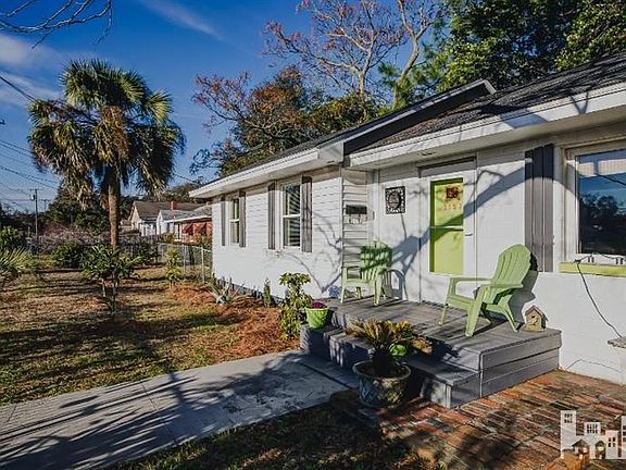 Beautifully landscaped, fully fenced yard with tropical foliage