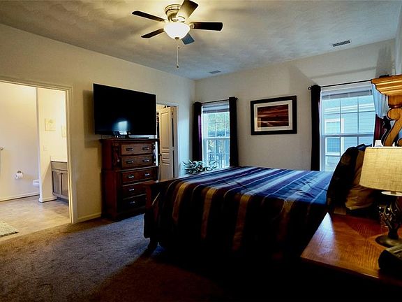 Primary bedroom suite has oversized doors, ceiling fan, walk-in closet with solid wood shelving, dual vanity, garden tub, lead-plated window, walk-in shower.