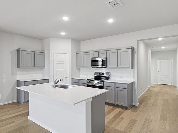 Kitchen in the Holden home plan by Trophy Signature Homes - REPRESENTATIVE PHOTO