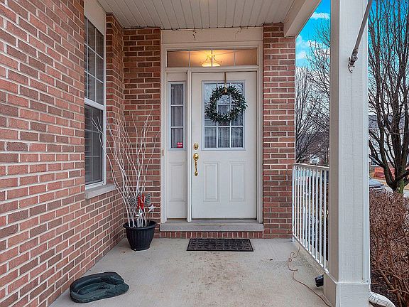 Inviting private front porch to greet guests.  Have dogs? This is the largest lot in the complex mea