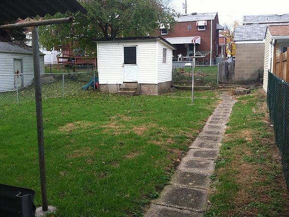 Level fenced backyard with shed