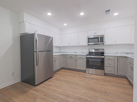 Open Kitchen Area with expansive cabinetry makes it ideal for storage.
