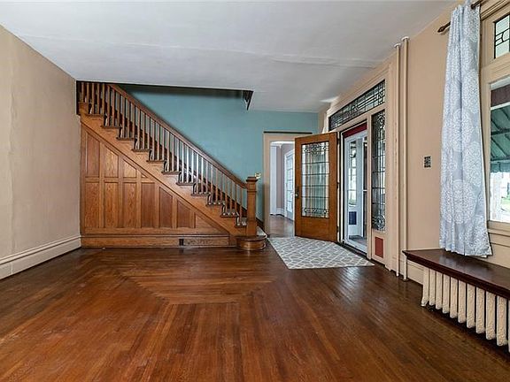 Family Room at front entry has beautiful oak staircase