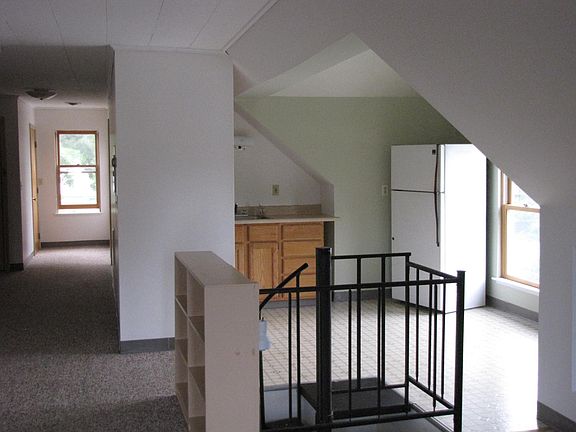 View to kitchen and entry hallway from living room.