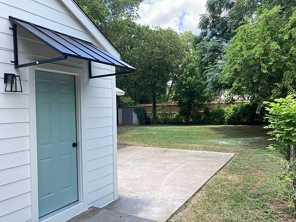 New back door with new awning. Large backyard with shed and concrete patio.