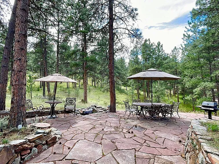 Ground level exit to patio with hot tub and gas grill