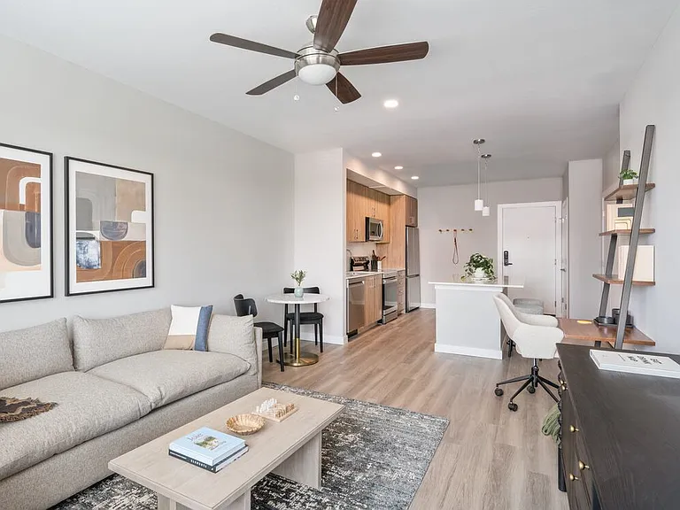 Living area with hard surface flooring and kitchen area