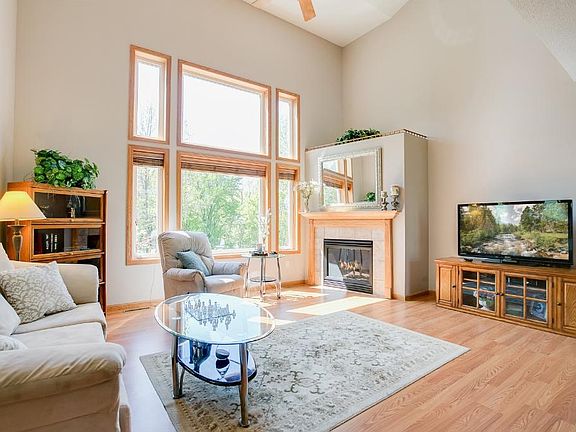Another angle of the living room showing the cozy fireplace.