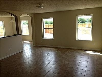  Huge family room with tile flooring with aches over the breakfast bar and entrance into your breakfast area.