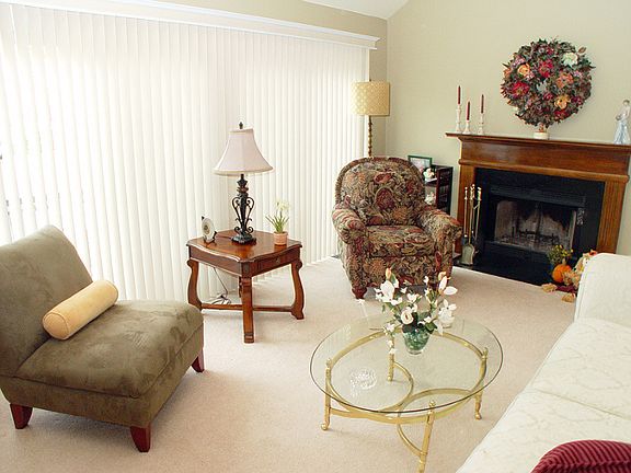 Living room features wood-burning fireplace with custom mantle