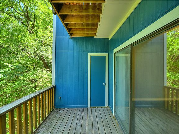 1st floor back porch balcony overlooking greenbelt. Door to additional outdoor storage unit.