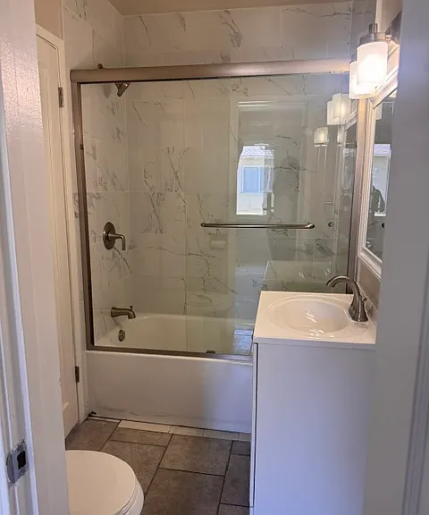 Full bathroom with recently updated shower, sink light and fixtures.