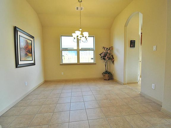Elegant Formal Dining Room with Unique High Ceilings with tall Arched Doorway leading into the Gourm