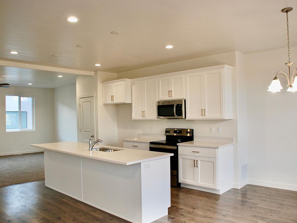 White cabinets with gold hardware and quartz countertops
