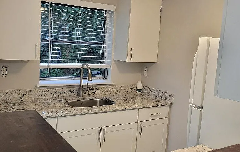 From Breakfast bar looking into kitchen towards sink & window.