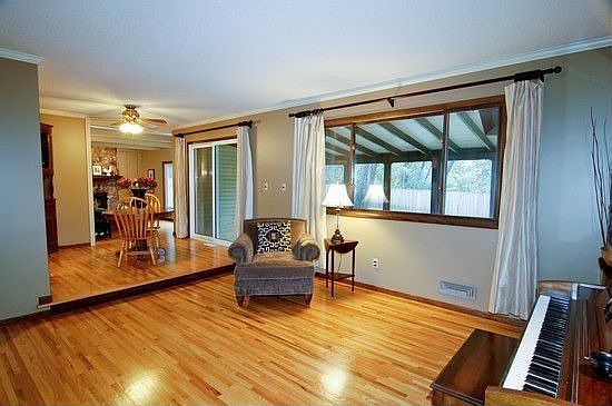 Living, dining room and famliy room view with sliding door to screened porch