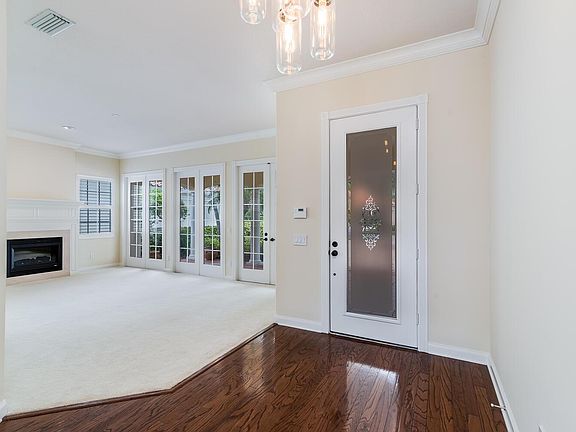 Glissening wood floors and pristine front fireplace room.