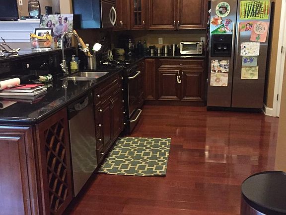 Large, open kitchen with beautiful cherry, hardwood floors.