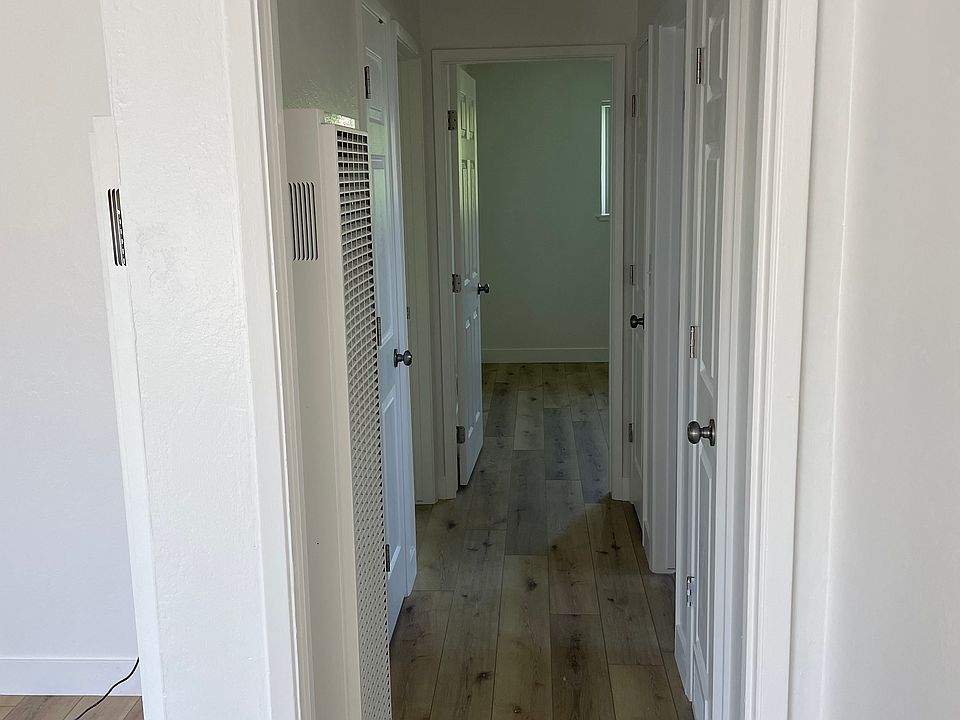 Hallway to bathroom and both bedrooms. Hall linen closet, and coat closet.
