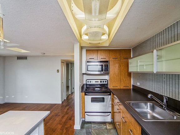 Kitchen with built-in microwave, dishwasher and lovely tiled backsplash