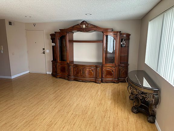 Lovely and spacious living room! With the front door and large window!