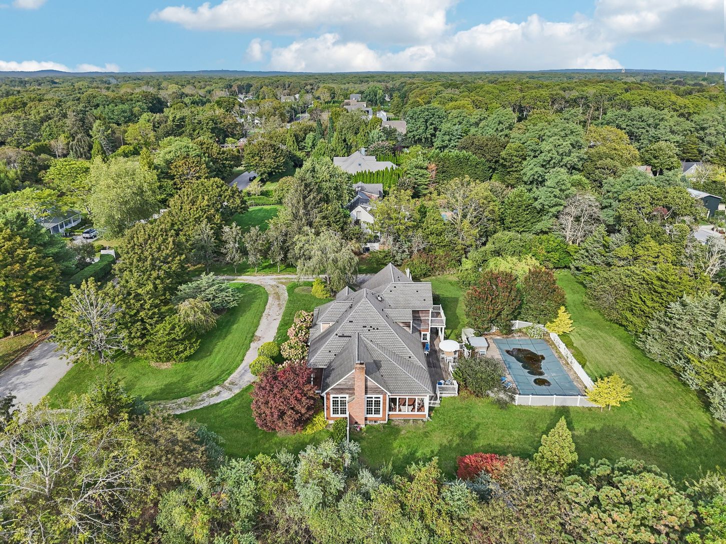 An aerial side perspective reveals the property’s architectural elegance.