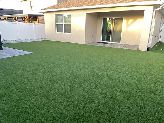 The patio is made of artificial grass