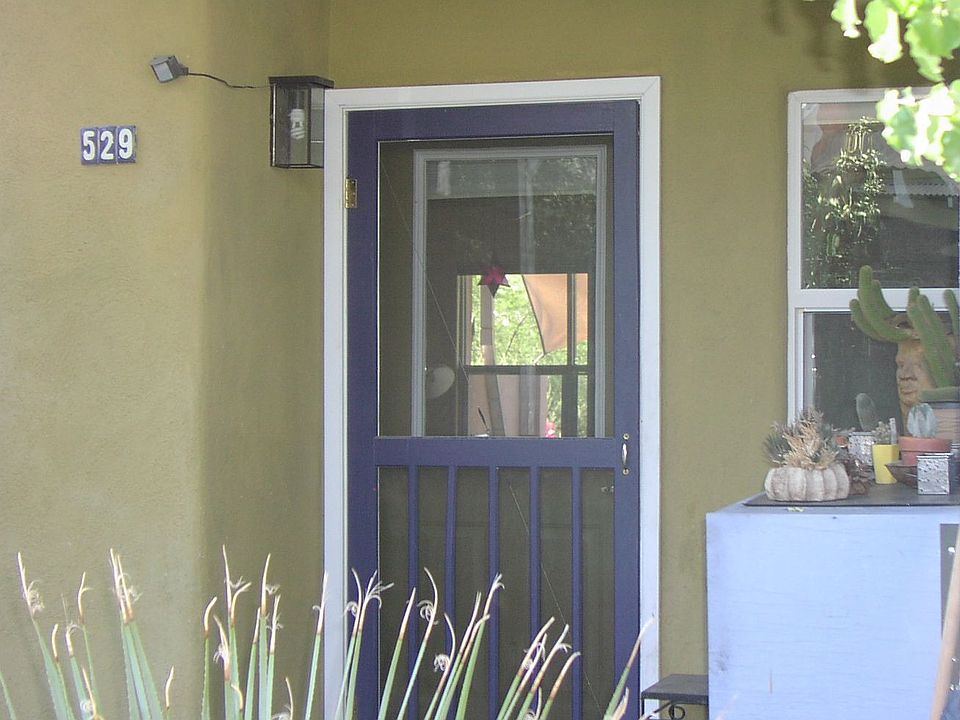 front door and blue bike storage locker