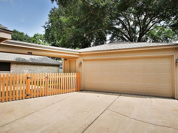 A fully fenced back yard will keep Fido from running off! Enjoy a covered breezeway from the home to the garage.