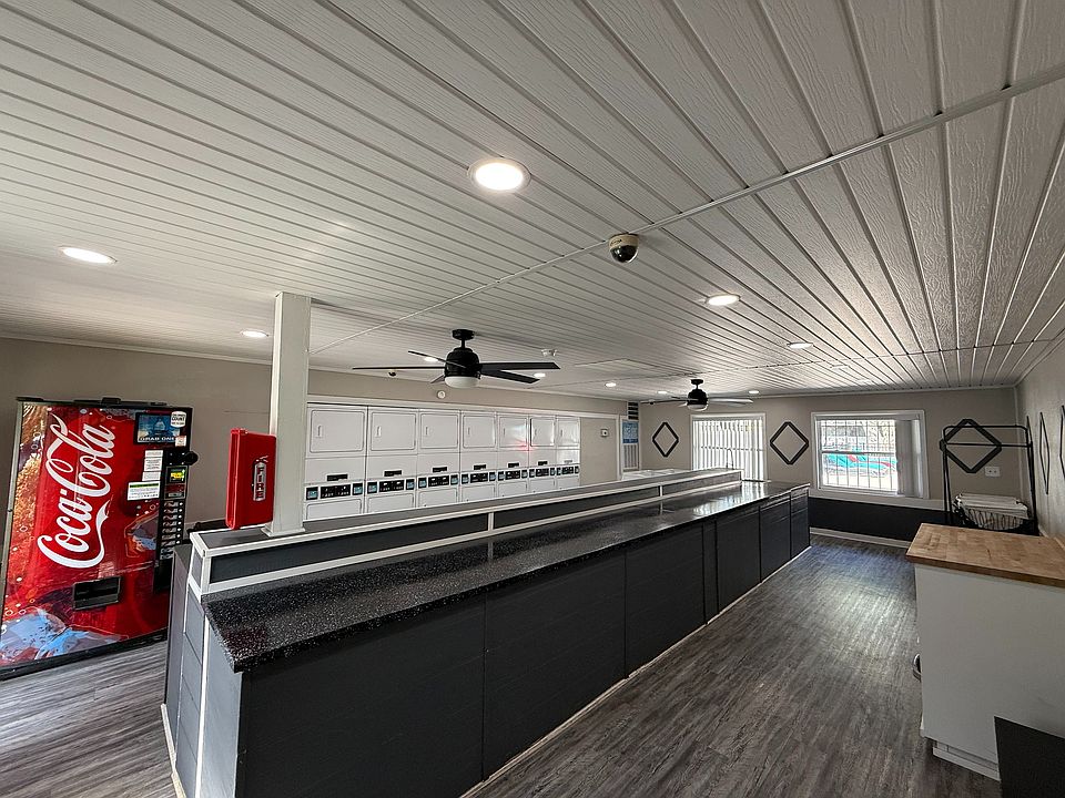 Modern laundry room with ample washers and dryers, sleek design, and convenient vending machine.