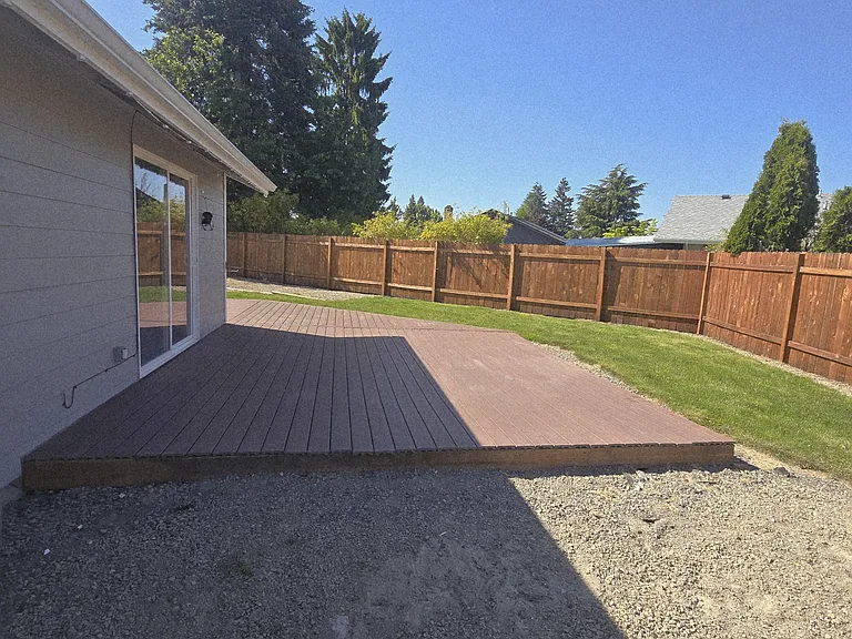 Backyard off living room; wraparound Trex deck.