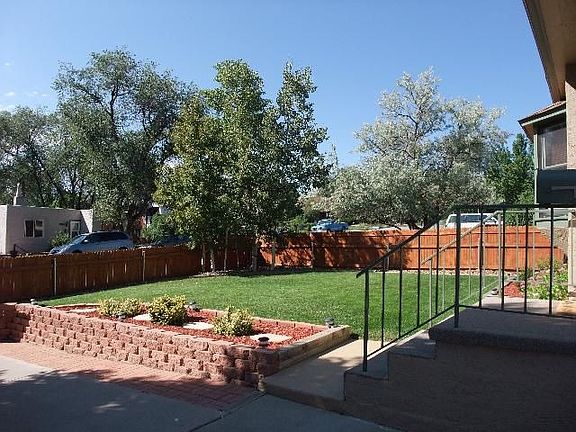 Lushly landscaped and fenced front yard.