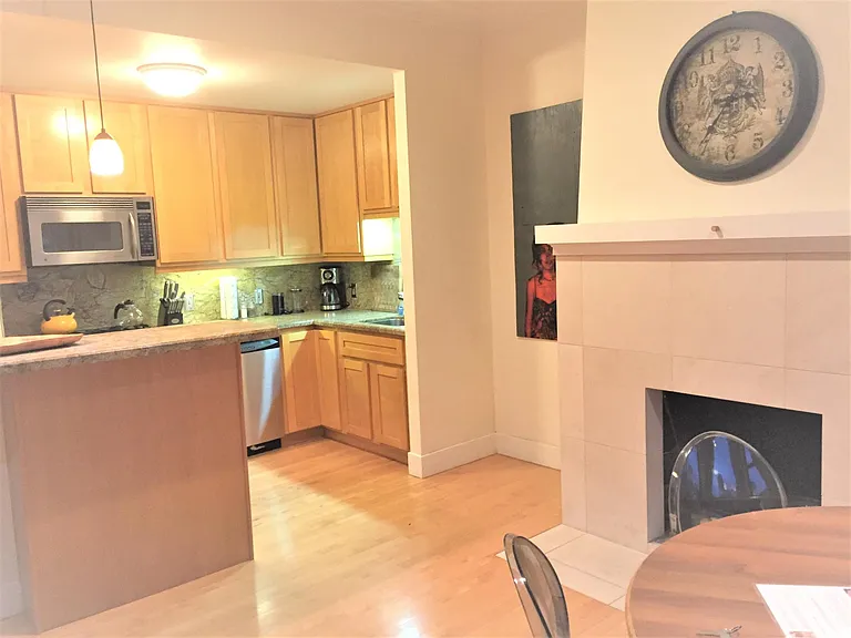 Open concept Kitchen flows into dining

Decorative limestone fireplace