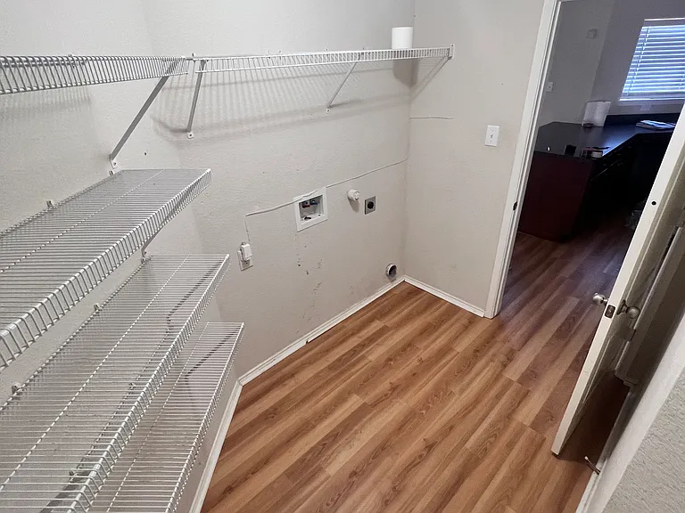 Entryway from garage/washer dryer hook up area & pantry space and then into kitchen shot