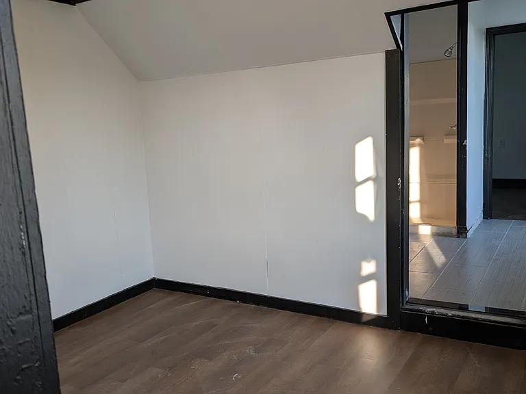 Second bedroom. This view is facing the door to the bathroom.
