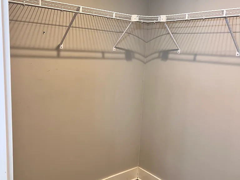 Walk in closet attached to en suite bathroom