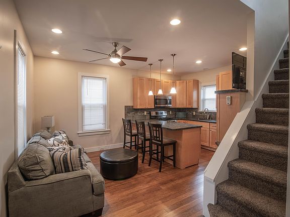 Open kitchen with microwave, dishwasher, five burner stove.