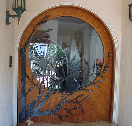 Sunburst Front entry
						:
						hinge is hand made tree with leaves