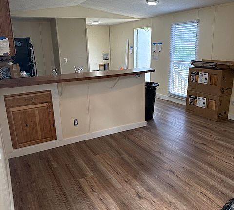 View from the front door, looking towards the kitchen and to the laundry area and back bedroom.
