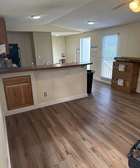 View from the front door, looking towards the kitchen and to the laundry area and back bedroom.