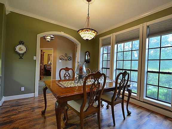 On the other side of the foyer is a large formal dining room with stunning architectural detail with