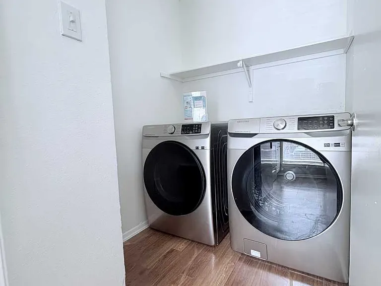 In-home laundry area with full-size washer and dryer for convenience.